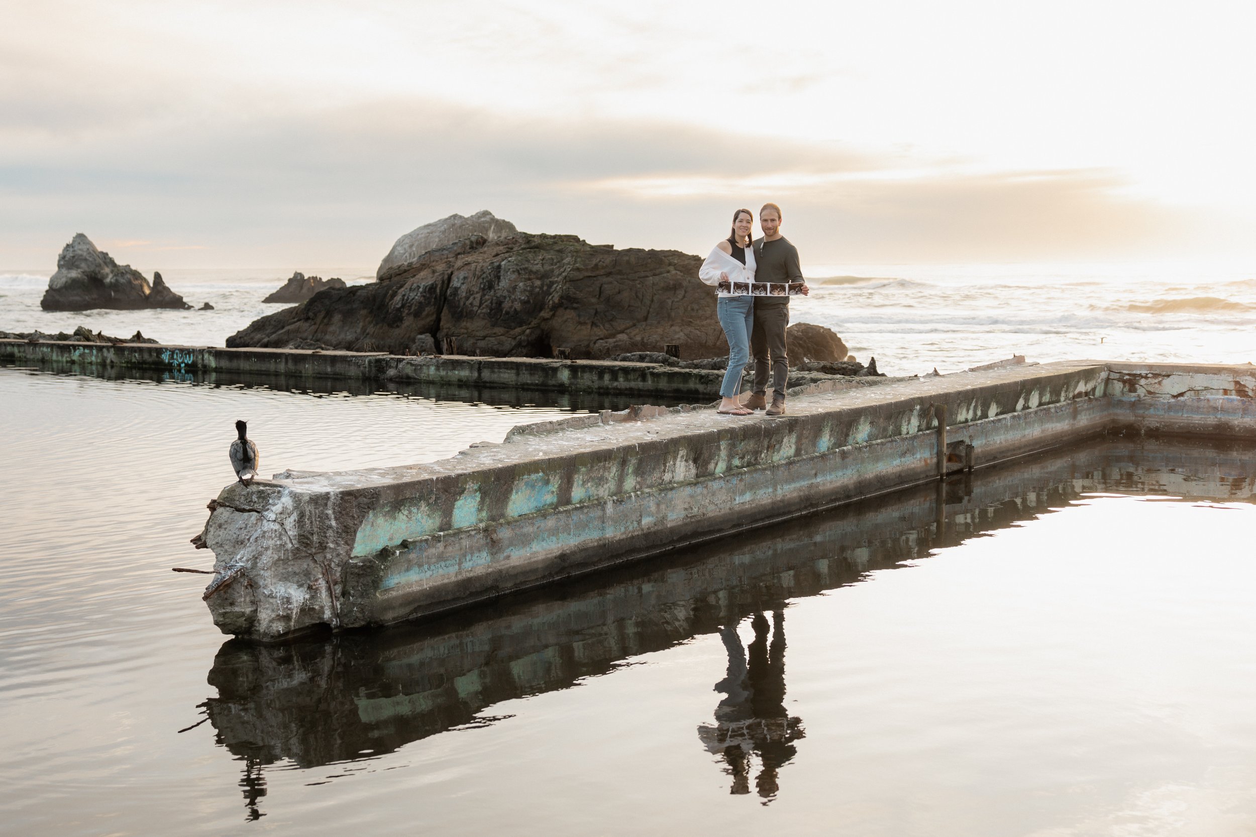 Parents to be with their ultrasound pictures at Sutro Baths in San Francisco